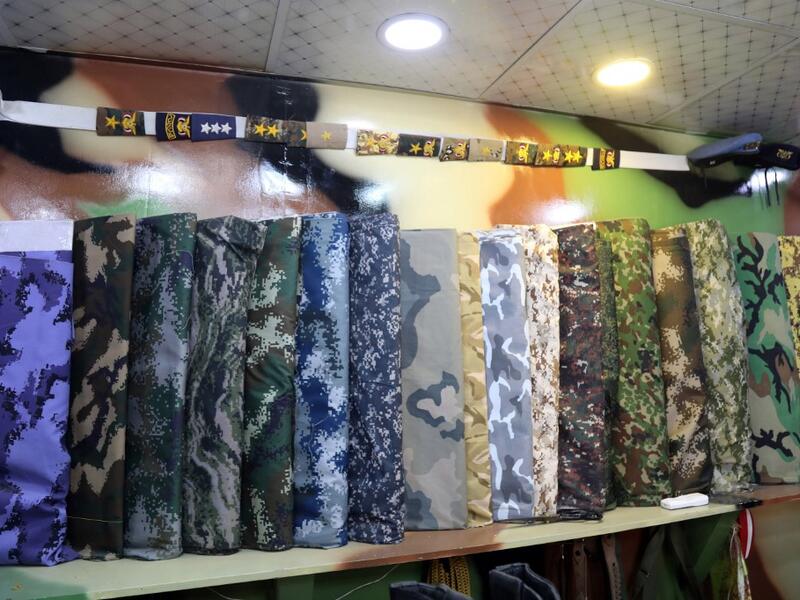A picture shows military camouflage textiles on display at a shop in Yemen's third city of Taez, on July 13, 2019. AHMAD AL-BASHA / AFP