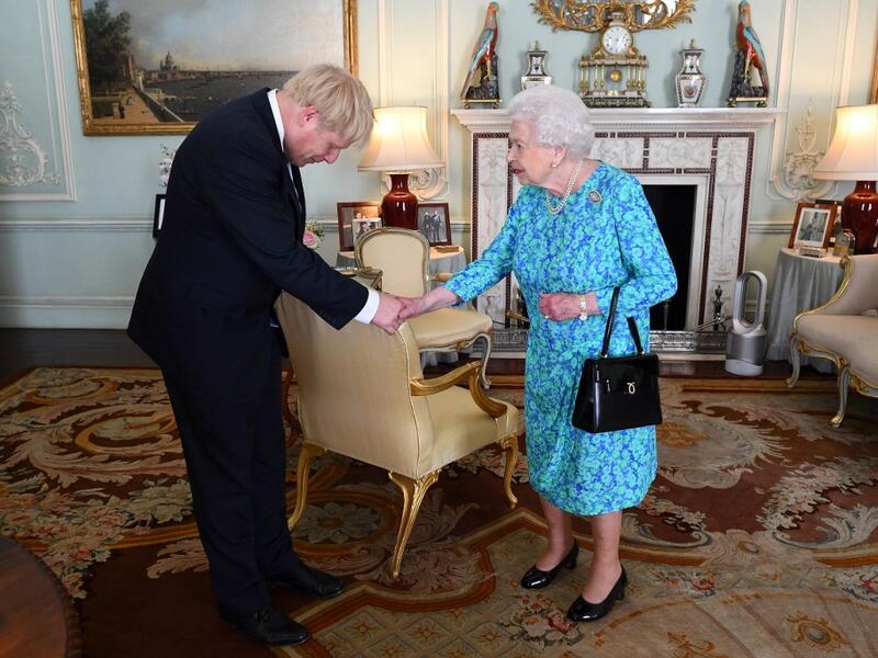 Britain's Queen Elizabeth II welcomes newly elected leader of the Conservative party, Boris Johnson during an audience in Buckingham Palace, London ON jULY 24, 2019, where she invited him to become Prime Minister and form a new government. Victoria Jones / POOL / AFP