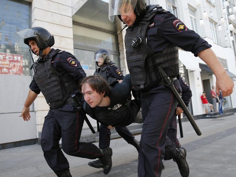Police officers detain a protester during an unauthorised rally demanding independent and opposition candidates be allowed to run for office in local election in September, in downtown Moscow on July 27, 2019.  Maxim ZMEYEV / AFP