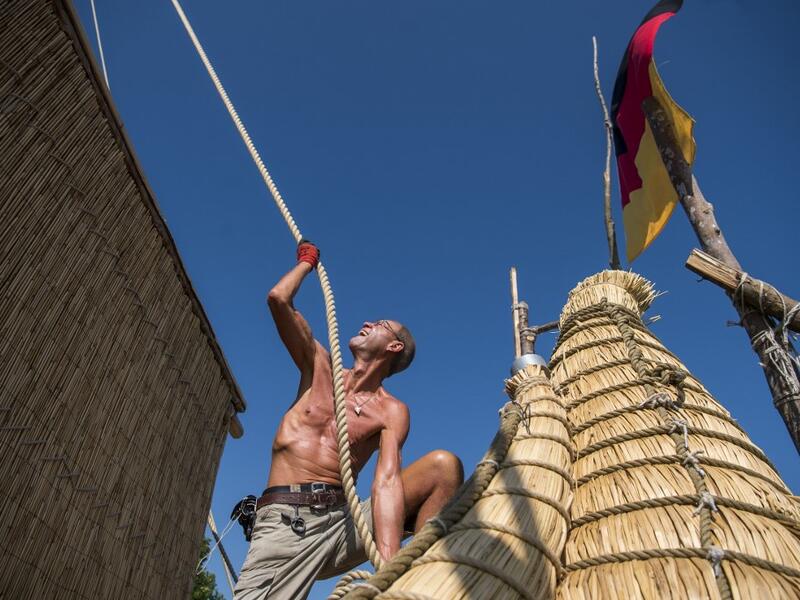 A member of the crew assembles the 14-meter long sailing reed boat Abora IV in the town of Beloslav, Bulgaria, on July 25, 2019. A team of two dozen researchers and volunteers from eight countries are preparing to set out in mid-August on a 1,300 kilometres (700 nautical mailes or 800 miles) journey to test the hypothesis that prehistoric trade routes traversed the high seas. NIKOLAY DOYCHINOV / AFP