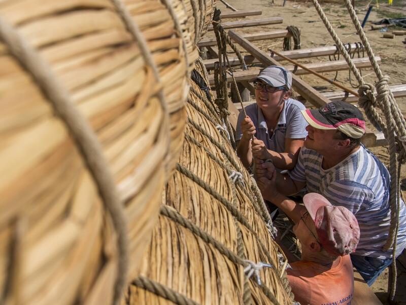 Members of the crew assemble the 14-meter long sailing reed boat Abora IV in the town of Beloslav, Bulgaria, on July 25, 2019. NIKOLAY DOYCHINOV / AFP