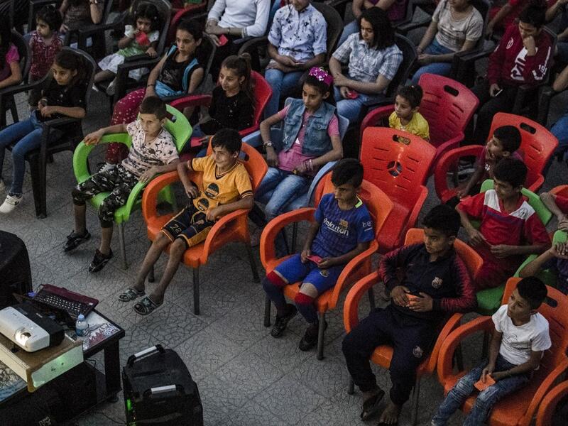 Hinde is screening films in remote villages using just a laptop, projector and a canvas screen. With some films dubbed into Kurdish and others subtitled, he and a team of volunteers want to spread their love of cinema across Rojava, the Kurdish name of the semi-autonomous northeast of war-torn Syria. DELIL SOULEIMAN / AFP