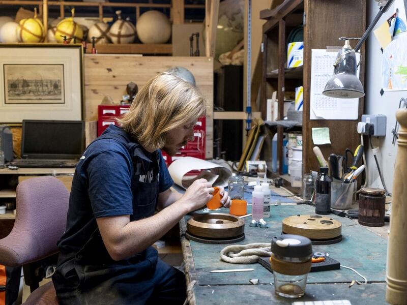A woodworker prepares a base for a globe at the Bellerby and Co Globemakers' workshop and headquarters in Stoke Newington in north London, on July 19, 2019. Niklas HALLE'N / AFP