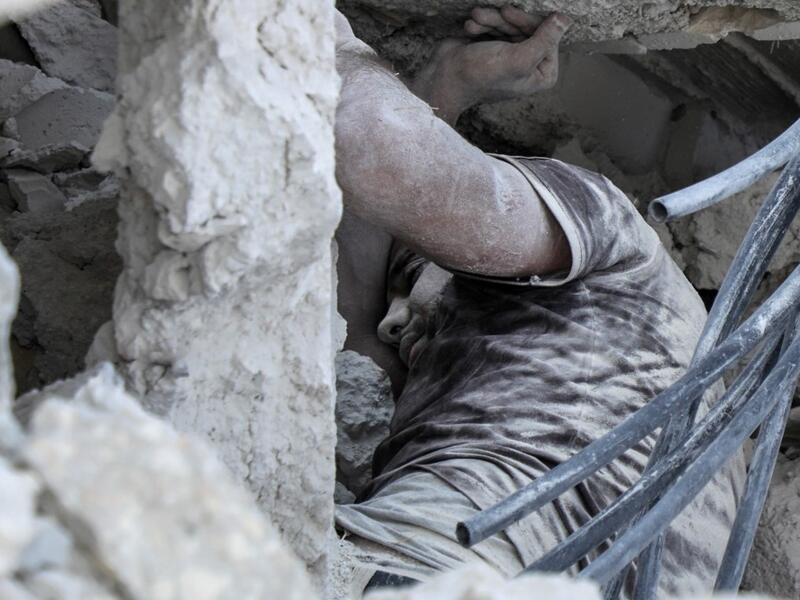 Syrian victim of a reported airstrike by regime forces on the town of Maaret Hurmah in the southern countryside of Syria's northwestern Idlib province (AFP)
