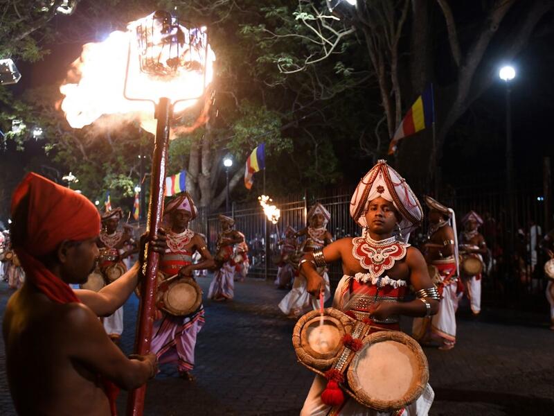 In this photograph taken on August 14, 2019 musicians perform during the "Esala Perahera" festival near the Buddhist temple of the Tooth in the ancient hill capital of Kandy, some 116 kilometres from Colombo. Lakruwan WANNIARACHCHI / AFP