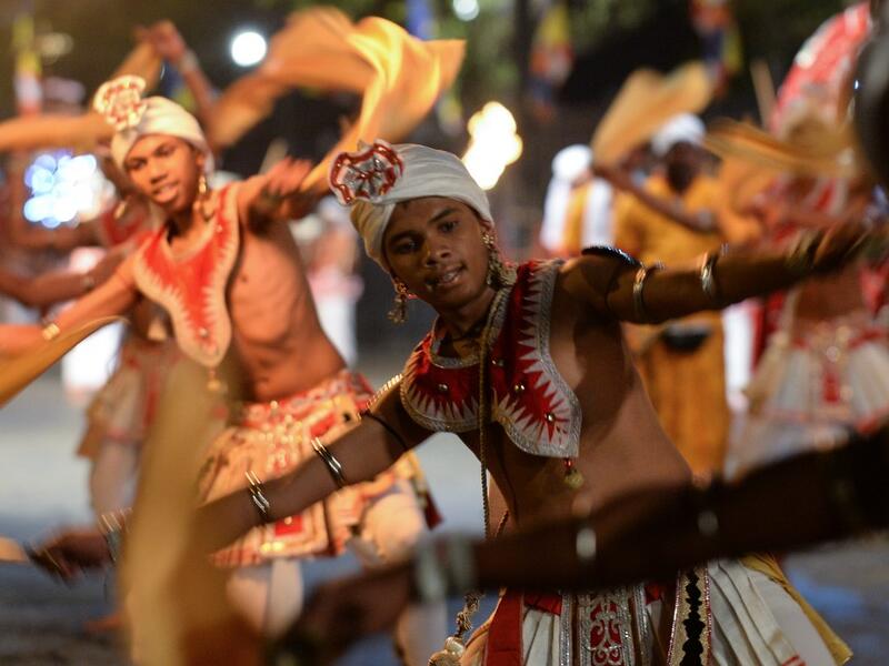 In this photograph taken on August 14, 2019 dancers perform during the "Esala Perahera" festival near the Buddhist temple of the Tooth in the ancient hill capital of Kandy, some 116 kilometres from Colombo. Lakruwan WANNIARACHCHI / AFP