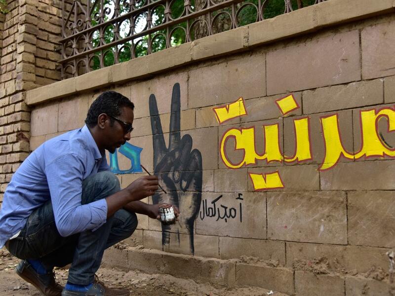 A Sudanese artist paints a mural on a wall in the capital Khartoum on August 22, 2019. (Ahmed Mustafa / AFP)