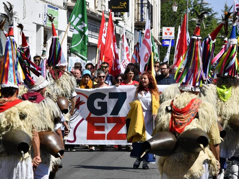 Demonstrators wear a traditional Basque shepherd costume, during a march in Hendaye, south-west France on August 24, 2019, against the annual G7 Summit. GEORGES GOBET / AFP