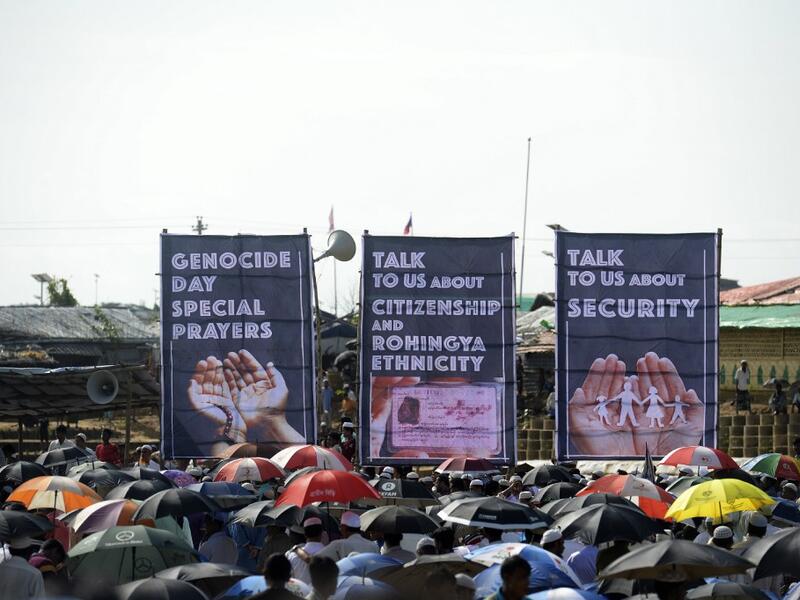 Rohingya refugees attend a ceremony organised to remember the second anniversary of a military crackdown that prompted a massive exodus of people from Myanmar to Bangladesh, at the Kutupalong refugee camp in Ukhia on August 25, 2019. MUNIR UZ ZAMAN / AFP