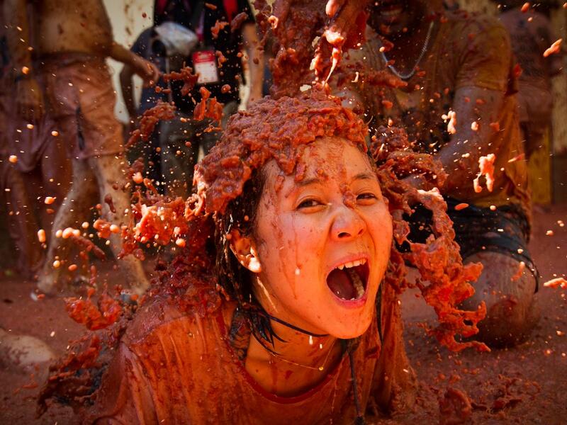 A reveller covered in tomato pulp participates in the annual "Tomatina" festival in the eastern town of Bunol, on August 28, 2019. JAIME REINA / AFP