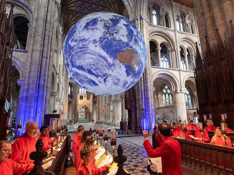 Choristers from Holy Trinity Church Coventry rehearse for evensong as Gaia, a 23ft replica of planet earth hangs on display (dailymail.co.uk)