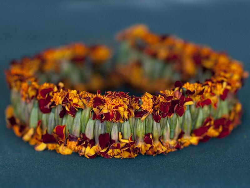 This garland is made from woven marigold heads, although most are made using fragrant wild jasmine and basil (Facebook)