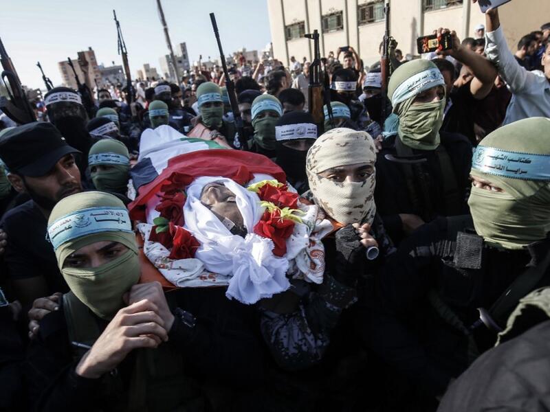 Palestinian fighters from the Fatah movement carry the shrounded body of Badreddin Abu Musa during his funeral procession in the city of Khan Yunis, in the southern Gaza Strip on August 31, 2019. (AFP/ File Photo)