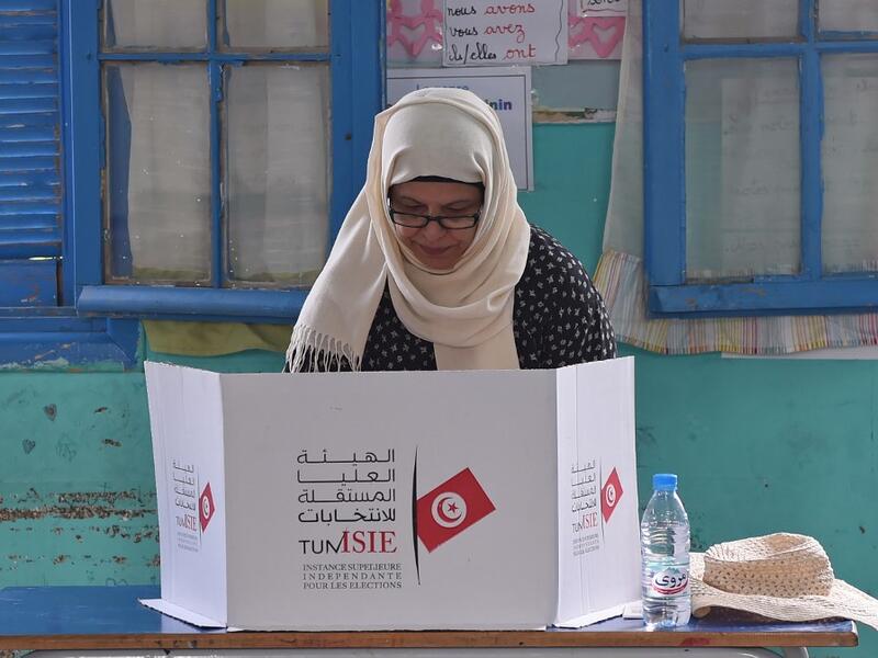 A Tunisian voter fills her ballot for presidential election at a polling station in Ben Arous near the capital Tunis, on September 15, 2019. (AFP/ File Photo)