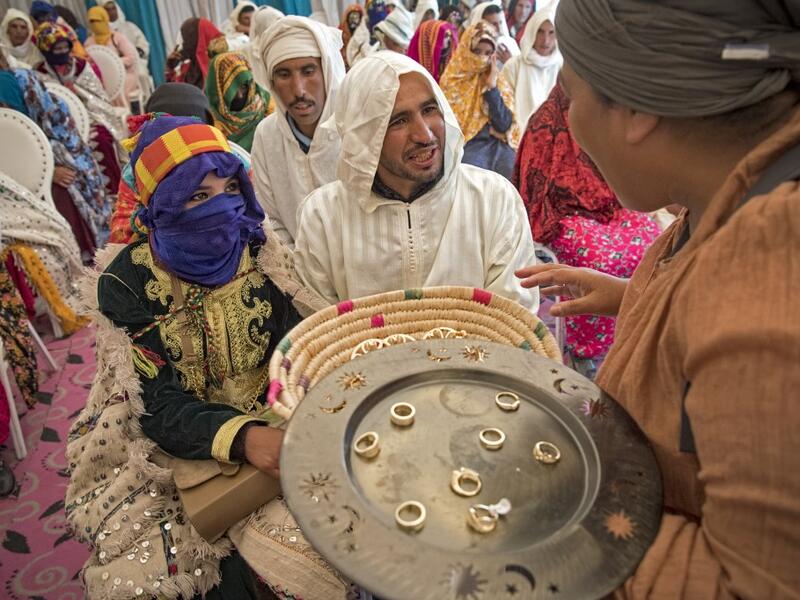 Young Amazigh (Berber) men and women wait for their wedding ceremony during the annual "Engagement Moussem" festival near the village of Imilchil in central Morocco's high Atlas Mountains on September 21, 2019. Each year in the High Atlas Mountains hamlet of Ait Amer, tribes celebrate with dances and music, the collective wedding of young Amazigh couples during the traditional festival of "Engagement Moussem". FADEL SENNA / AFP