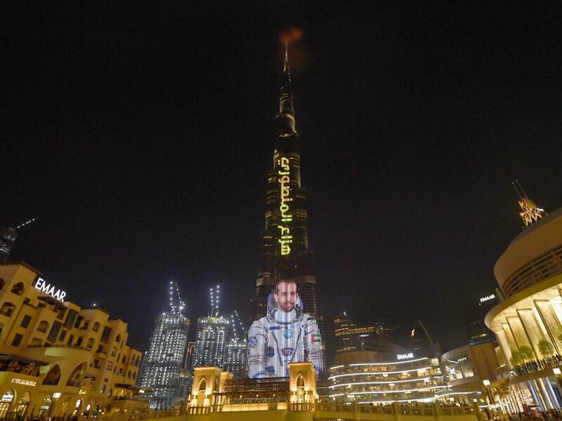A picture taken on September 25, 2019, shows the Gulf emirate's Burj Khalifa, the world's tallest skyscraper, lit with an image of 35-year-old Emirati astronaut Hazzaa al-Mansoori, who is set to spend eight days aboard the International Space Station (ISS). (AFP/ File Photo)