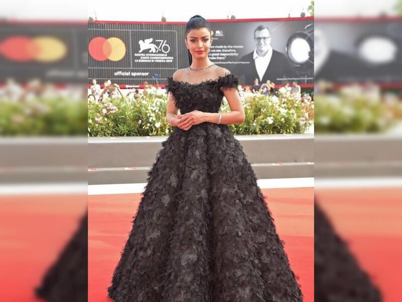 Saudi actress Mila Al Zahrani sported a black gown with feathers for her first look