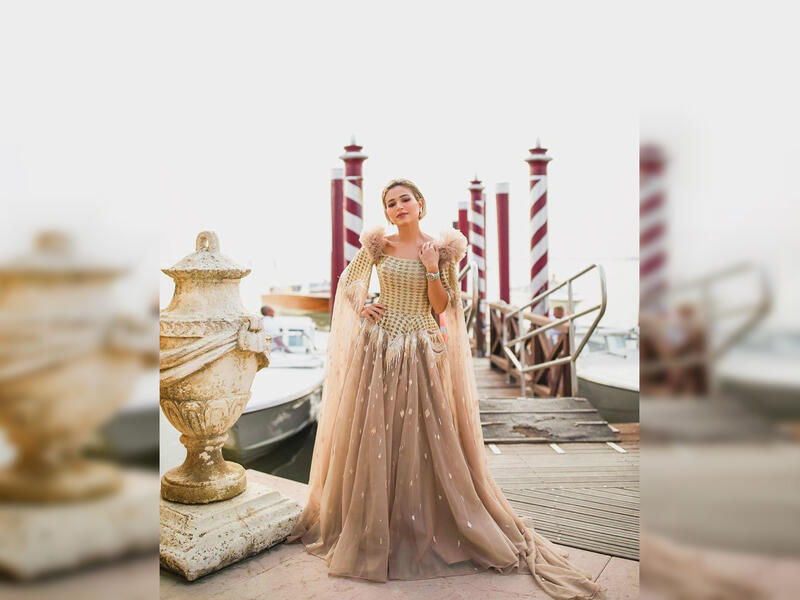 Kuwaiti poet and TV personality Noha Nabil dazzled in a golden dress by fashion house LaBourjoisie