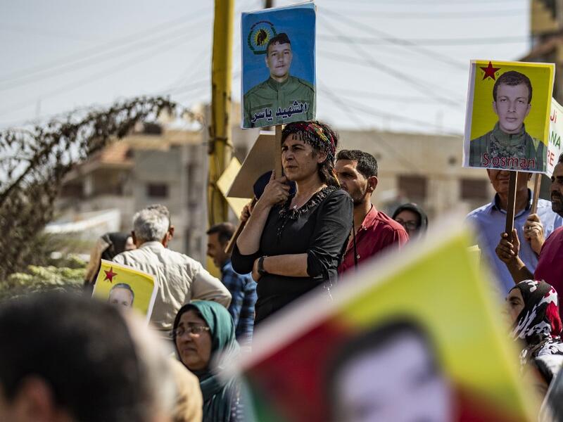 Syrian Kurds demonstrate in front of the United Nations offices in the Kurdish-majority city of Qamishli in northeast Syria on October 2, 2019 over their exclusion from the UN-backed constitutional committee. The United Nations on September 23 announced the long-awaited formation of the committee which includes the government and opposition, but it remained to be seen if the step could finally end the civil war. Delil SOULEIMAN / AFP