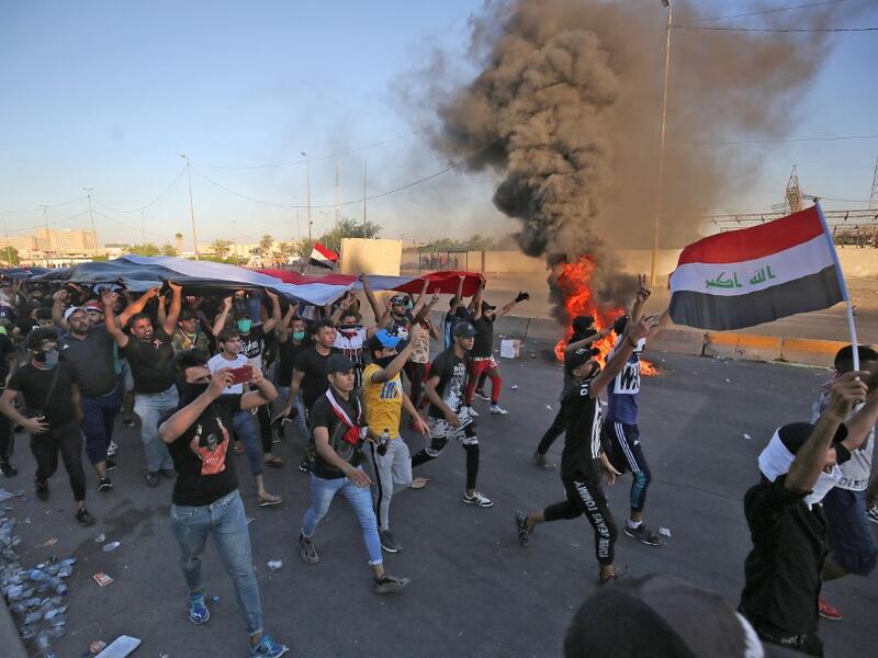Iraqi security forces said "unidentified snipers" killed four people across the capital Baghdad today, the fourth day of violent anti-government protests. AHMAD AL-RUBAYE / AFP