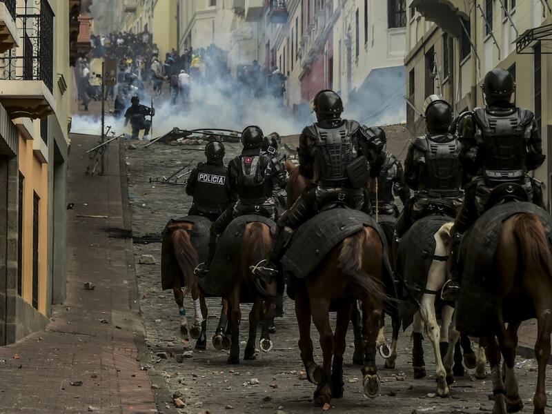 Mounted police confront demonstrators during clashes in Quito as thousands march against Ecuadorean President Lenin Moreno's decision to slash fuel subsidies, on October 9, 2019. Rodrigo BUENDIA / AFP