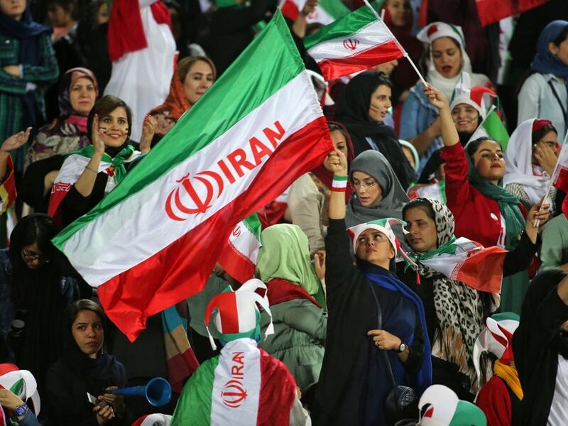 The Islamic republic has barred female spectators from football and other stadiums for around 40 years, with clerics arguing they must be shielded from the masculine atmosphere and sight of semi-clad men. Women fans are attending the football match freely for the first time in decades, after FIFA threatened to suspend the country over its controversial male-only policy.  ATTA KENARE / AFP