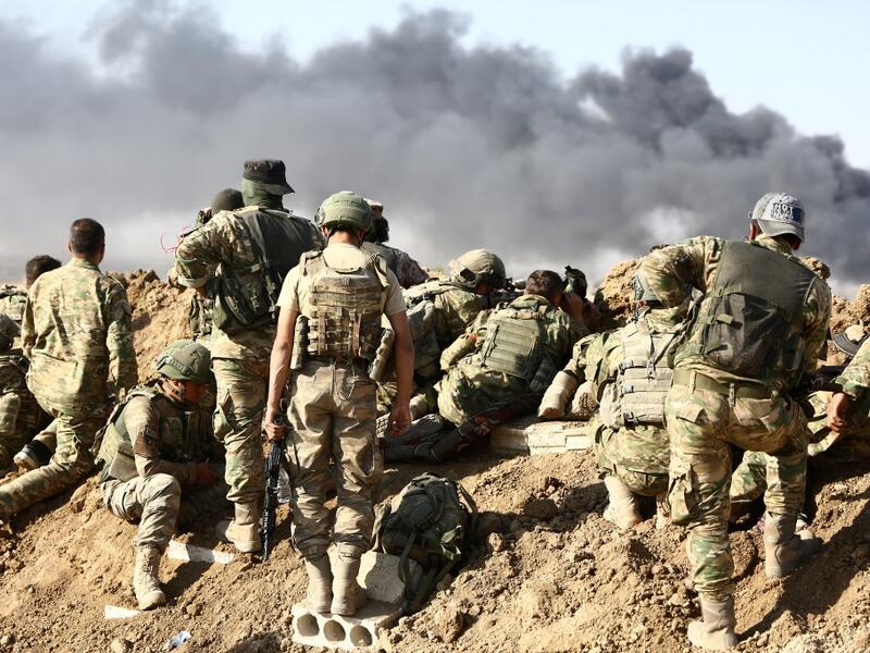 Turkish troops and Turkish-backed Syrian rebels gather outside the border town of Ras al-Ain on October 12, 2019, during their assault on Kurdish-held border towns in northeastern Syria. (AFP/ File Photo)