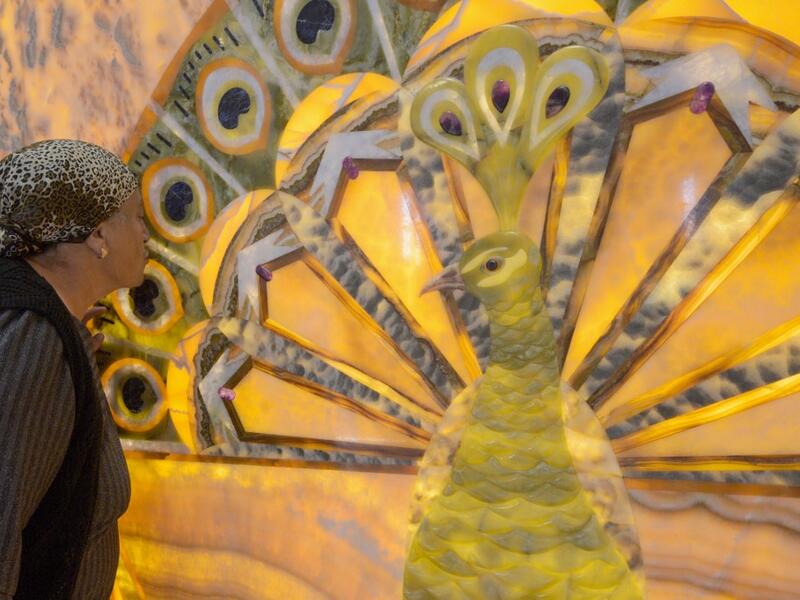 A woman kisses an image of the Melek Taus, or the Peacock Angel, in the new Yazidi Temple in the village of Aknalich, 35 kilometres from the Armenian capital Yerevan,  KAREN MINASYAN / AFP