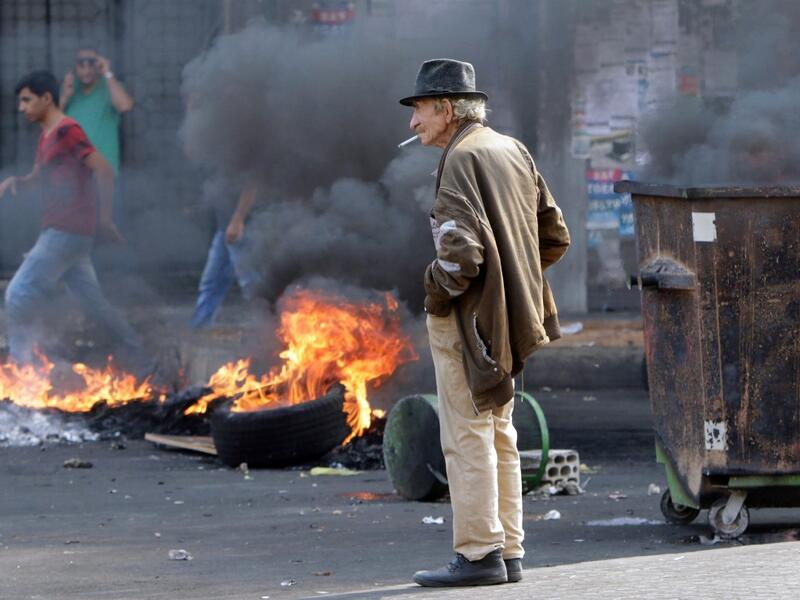 Lebanese demonstrators burn tires during a protest against dire economic conditions, on October 18, 2019 in the northern port city of Tripoli The Lebanese government faced calls to resign Thursday after thousands of furious demonstrators took to the streets across the country to protest dire economic conditions. Ibrahim CHALHOUB / AFP