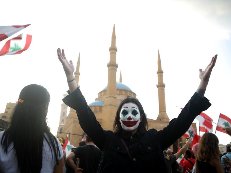 A Lebanese demonstrator, her face painted as DC comic book and film character "The Joker", takes part in a protest in the capital Beirut's downtown district's Martyr's Square on October 19, 2019. (AFP/ File Photo)