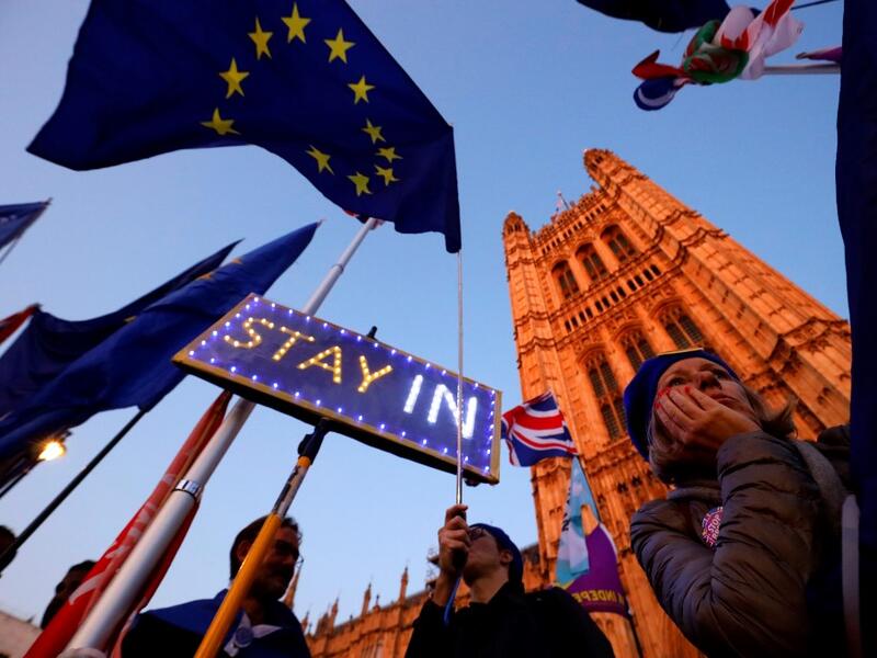 Banners, Union and EU flags are displayed outside the Houses of Parliament in London on October 22, 2019, as MPs debate the second reading of the Government's European Union (Withdrawal Agreement) Bill. (AFP/ File Photo)