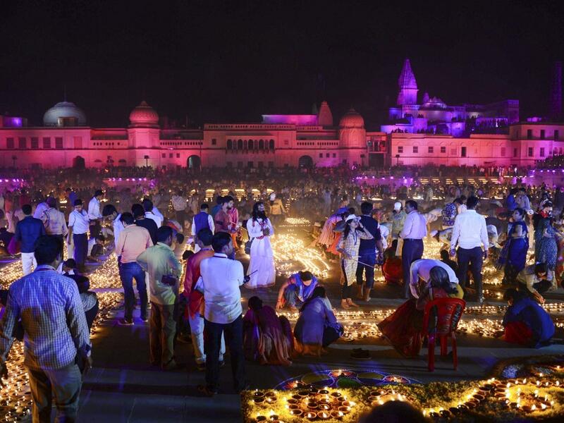 Hindu devotees light earthen lamps on the banks of the River Sarayu on the eve of "Diwali" festival during an event organised by the Uttar Pradesh government, in Ayodhya on October 26, 2019. "Diwali", the Festival of Lights, marks victory over evil and commemorates the time when Hindu god Lord Rama achieved victory over Ravana and returned to his kingdom Ayodhya. SANJAY KANOJIA / AFP