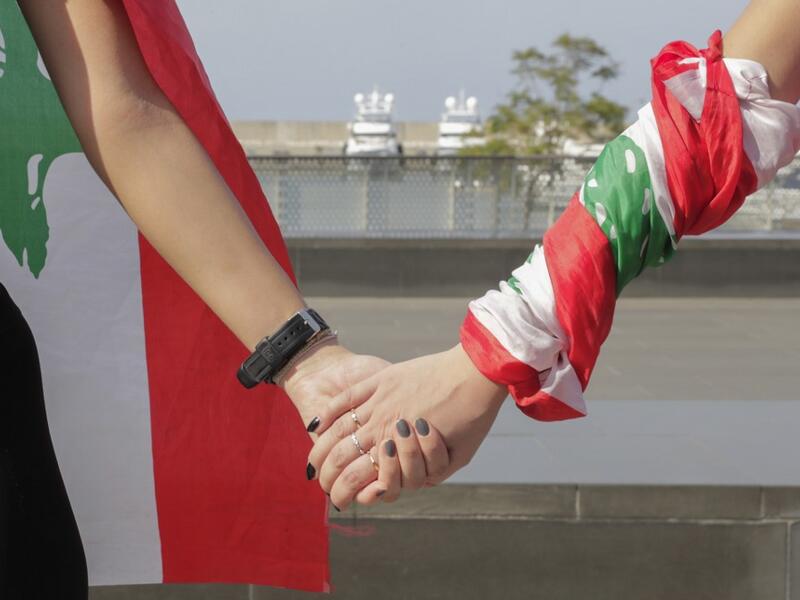 Lebanese protesters hold hands to form a human chain along the coast from north to south as a symbol of unity, during ongoing anti-government demonstrations in Lebanon's capital Beirut on October 27, 2019. ANWAR AMRO / AFP