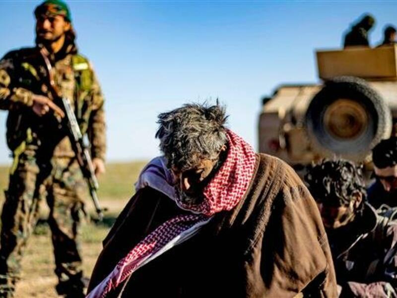 Men and boys suspected of being Daesh elements wait to be searched by members of the Kurdish-led Syrian Democratic Forces (SDF) after leaving the Daesh last holdout of Baghuz, Dayr al-Zawr Province, Syria, on March 1, 2019. (Photo by AFP)