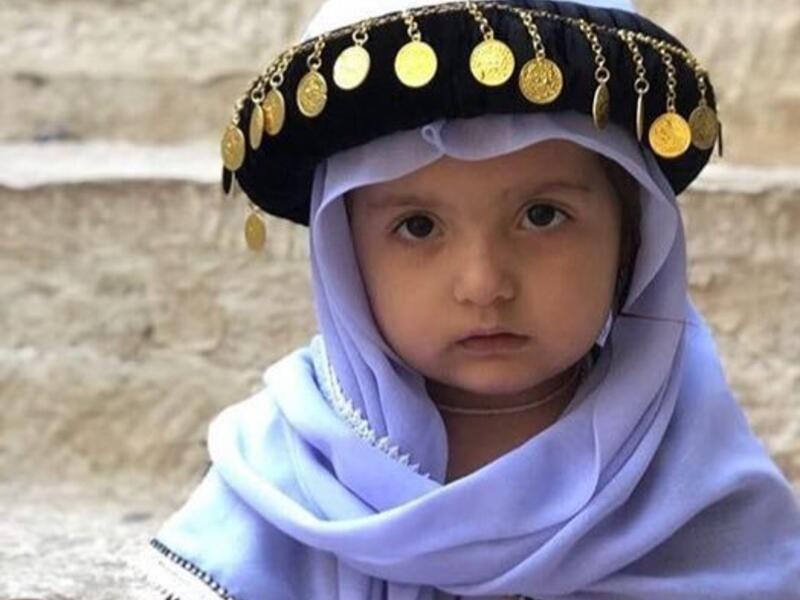 Photo of little Yezidi child in Yezidi traditional clothes in Lalish Temple the holiest Yezidi Religious Site in the world (Twitter)