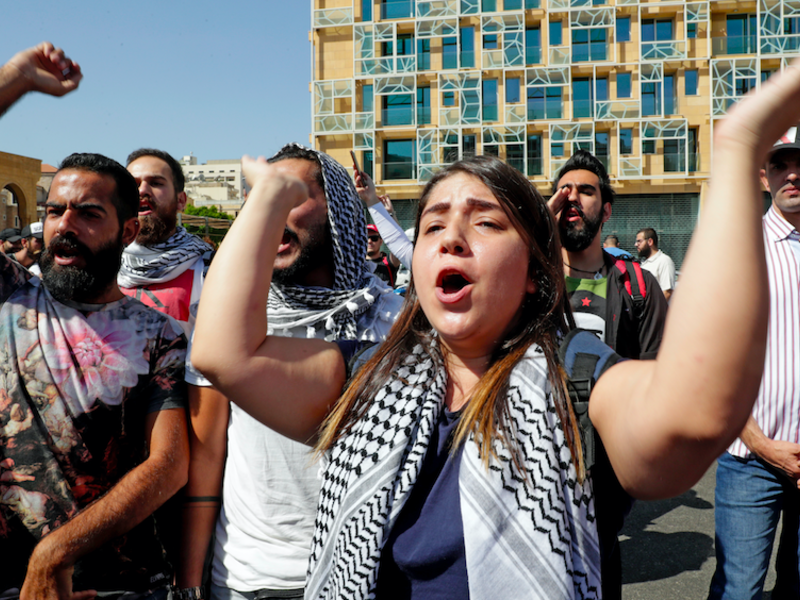 Lebanese protesters chants slogans during a demonstration in central Beirut's Martyr Square on October 6, 2019. Lebanese protested in the capital over increasingly difficult living conditions, amid fears of a dollar shortage and possible price hikes. (AFP)