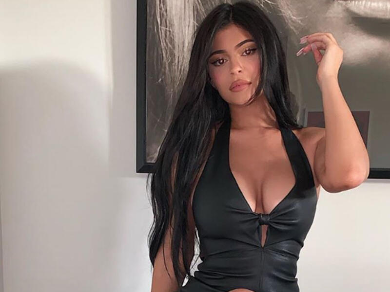 She wore a  black leather Christian Cowan dress.