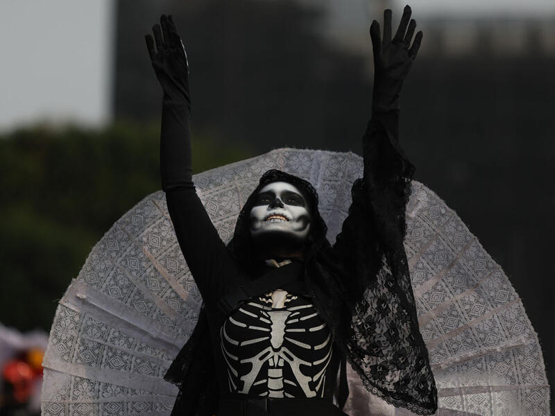 A costumed participant walks in the annual International Day of the Dead Parade in Mexico City  Emilio Espejel / Anadolu Agency / Getty