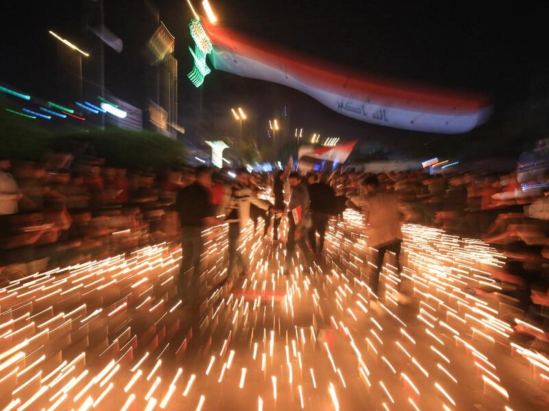 Iraqi protesters hold a candlelight vigil for victims killed during ongoing anti-government demonstrations in the Shiite shrine city of Karbala, south of Iraq's capital Baghdad, on November 2, 2019 Iraqi security forces clashed with anti-government protesters near the capital's Tahrir Square today as anti-government rallies which have rocked Baghdad for a month cost more lives. Mohammed SAWAF / AFP