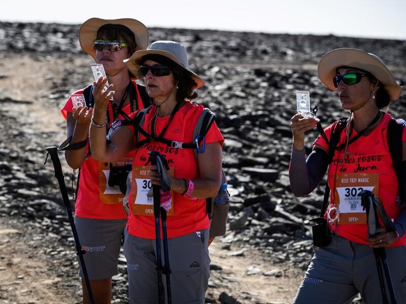 Women take part in the desert trek "Rose Trip Maroc", on November 3, 2019 in the erg Chebbi near Merzouga. The Rose Trip Maroc is a female-oriented trek where teams of three must travel through the southern Moroccan Sahara desert with a compass, a map and a topographical reporter. JEAN-PHILIPPE KSIAZEK / AFP
