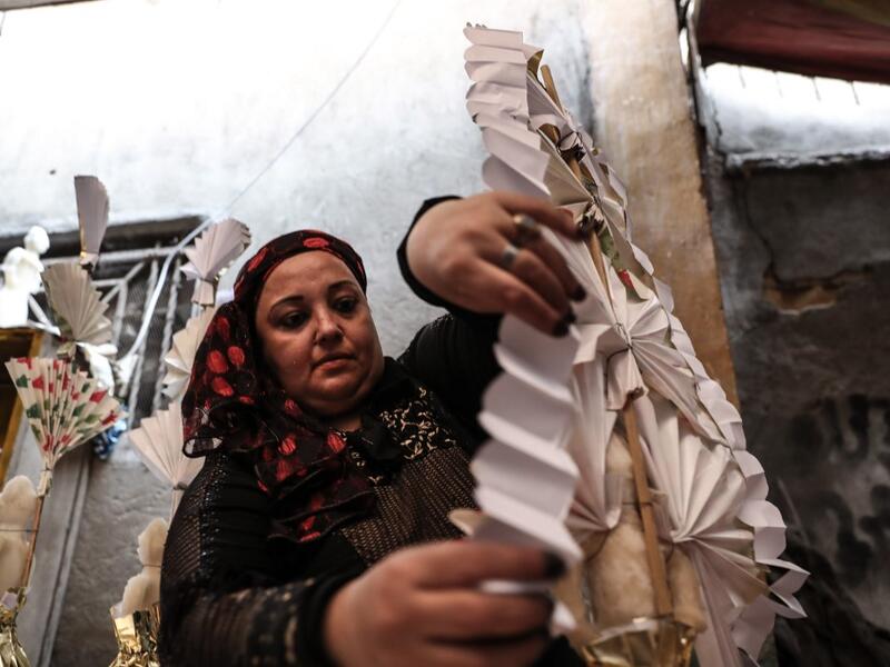 An Egyptian woman decorates traditional sugar statuettes in the capital Cairo on November 2, 2019, ahead of celebrations of the Muslim Prophet Mohammed's birthday, known as "Al Mawlid Al Nabawi". Prophet Mohamed was born in Saudi Arabia's arid mountainous city of Mecca, the holiest in Islam, some 1490 years ago. Sunni Muslims in many parts of the world celebrate his birthday on the 12th day of the third month of the Islamic calendar, which will fall this year on November 9th.  Mohamed el-Shahed / AFP