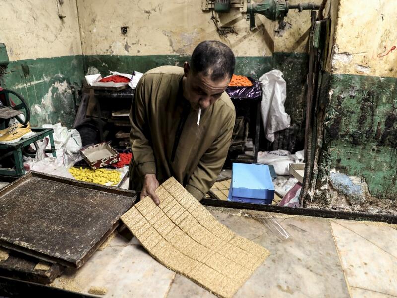 An Egyptian confectioner shows bars of sweets with sesame at a candy factory in the capital Cairo on November 2, 2019, ahead of celebrations of the Muslim Prophet Mohammed's birthday, known as "Al Mawlid Al Nabawi". Prophet Mohamed was born in Saudi Arabia's arid mountainous city of Mecca, the holiest in Islam, some 1490 years ago. Sunni Muslims in many parts of the world celebrate his birthday on the 12th day of the third month of the Islamic calendar, which will fall this year on November 9th.  Mohamed el