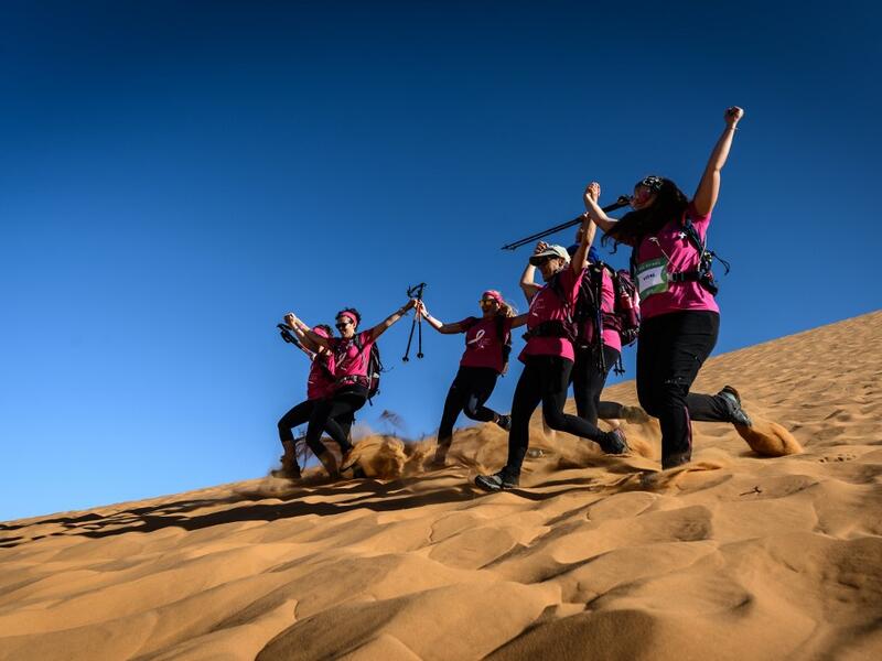 Women run down a sand dune as they take part in the desert trek "Rose Trip Maroc", on November 4, 2019 in the erg Chebbi near Merzouga. The Rose Trip Maroc is a female-oriented trek where teams of three must travel through the southern Moroccan Sahara desert with a compass, a map and a topographical reporter. JEAN-PHILIPPE KSIAZEK / AFP