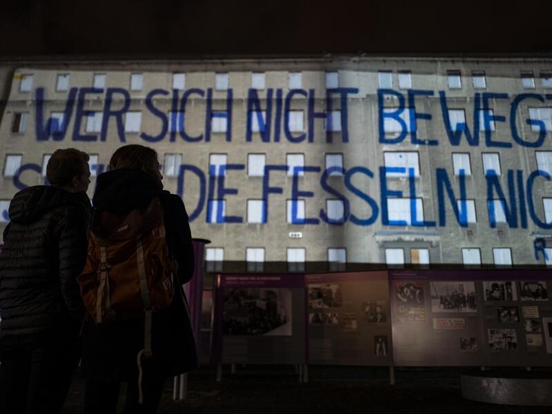 A giant banner reading: "He who does not move can not feel his restraints" is projected on the walls of the former Stasi (Former east German secret police) headquarters during the city-wide kick-off of the festival week to celebrate the 30th anniversary of the November 9,1989 fall of the Berlin Wall, in Berlin on November 4, 2019. Germany marks three decades since the fall of the Berlin Wall this week with main celebrations on November 9, 2019. John MACDOUGALL / AFP