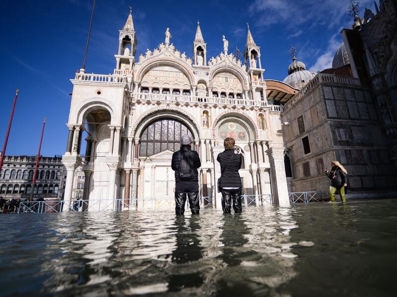 A general view shows the flooded St. Mark's Square, with St. Mark's Basilica (C) on November 14, 2019 in Venice. Much of Venice was left under water after the highest tide in 50 years ripped through the historic Italian city, beaching gondolas, trashing hotels and sending tourists fleeing through rapidly rising waters. Filippo MONTEFORTE / AFP