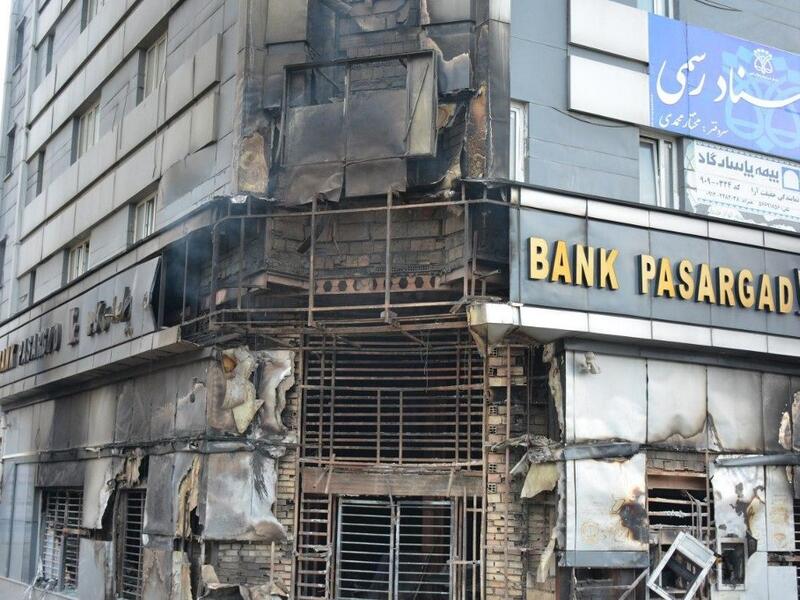 A picture taken on November 17, 2019 shows a scorched branch of Iranian Pasargad bank that was set ablaze by protesters during a demonstration against a rise in gasoline prices in Eslamshahr, near the Iranian capital of Tehran.  AFP