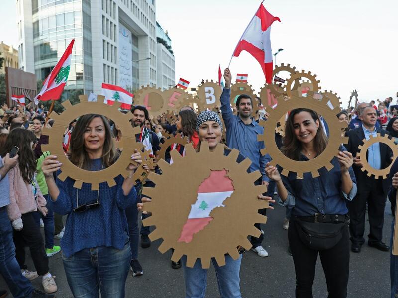 Lebanese demonstrators take part in a civilian Independence Day parade in Beirut's Martyr Square on November 22, 2019, more than a month into protests demanding an overhaul of the entire political system. (AFP/ File Photo)