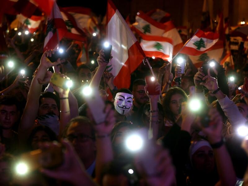 Lebanese demonstrators take part in a civilian Independence Day parade in Beirut's Martyr Square on November 22, 2019, more than a month into protests demanding an overhaul of the entire political system. Lebanese celebrated 76 years of national self-rule Friday, tens of thousands massing for joyous street festivities rather than stiff military parades to hail what a new protest movement calls "real independence". Patrick BAZ / AFP