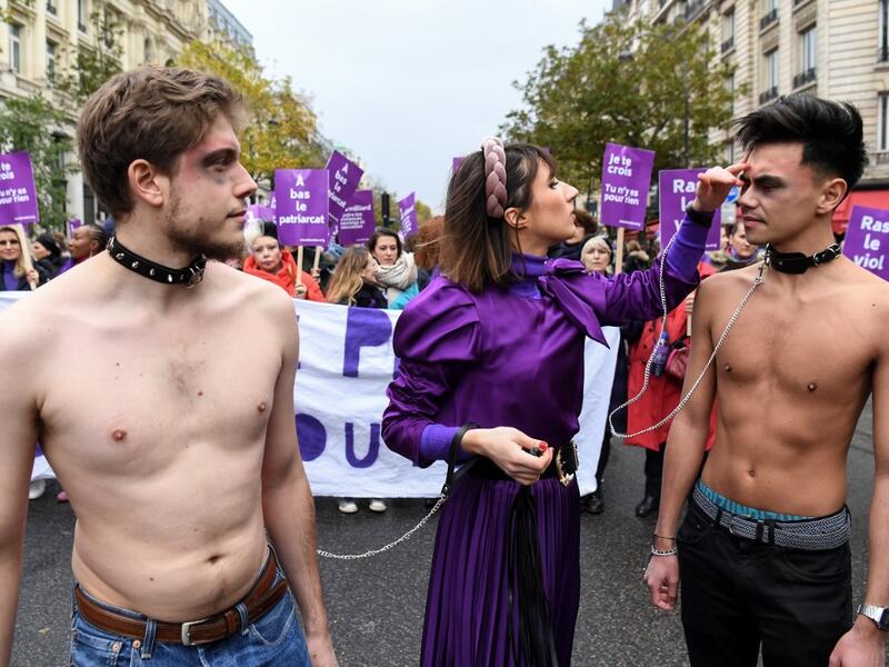 French comedian Marie Benoliel aka 'Marie S'Infiltre' (C) is seen during a protest to condemn violence against women, on November 23, 2019, in Paris. Alain JOCARD / AFP