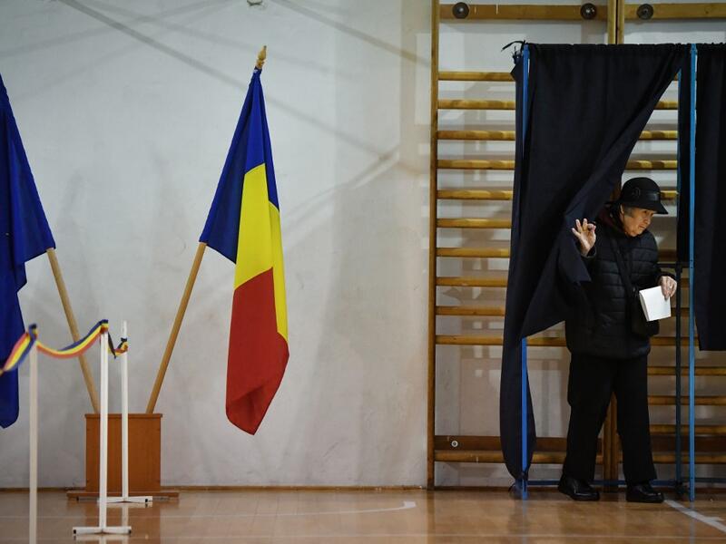 A woman leaves a voting booth on the second round of presidential elections at a poll station in Bucharest November 24, 2019. (AFP/ File Photo)